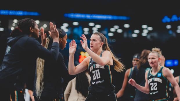 Ionescu (20) is greeted by Liberty teammates during a timeout in Game 3 action